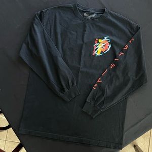 Black and multicolored Primitive long sleeve with design on shirt, size large .